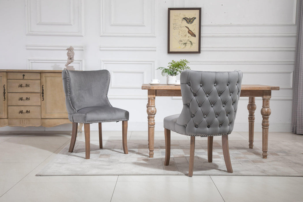 Set of 2 upholstered wing-back dining chair with backstitching nailhead trim and solid wood legs