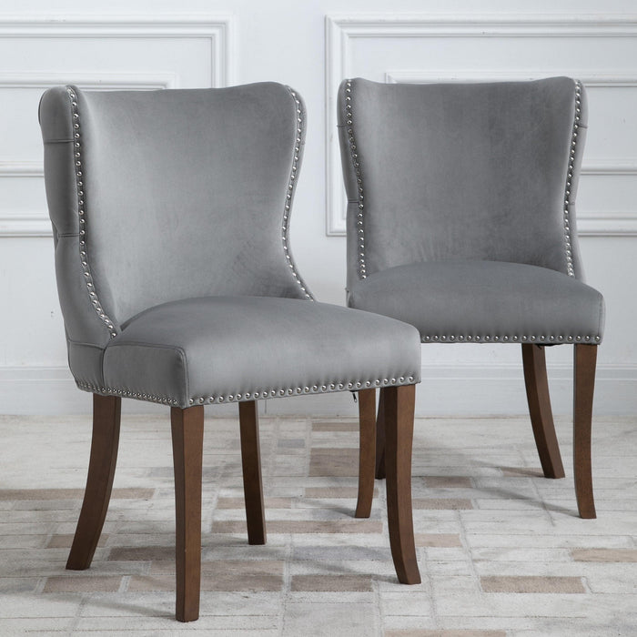 Set of 2 upholstered wing-back dining chair with backstitching nailhead trim and solid wood legs